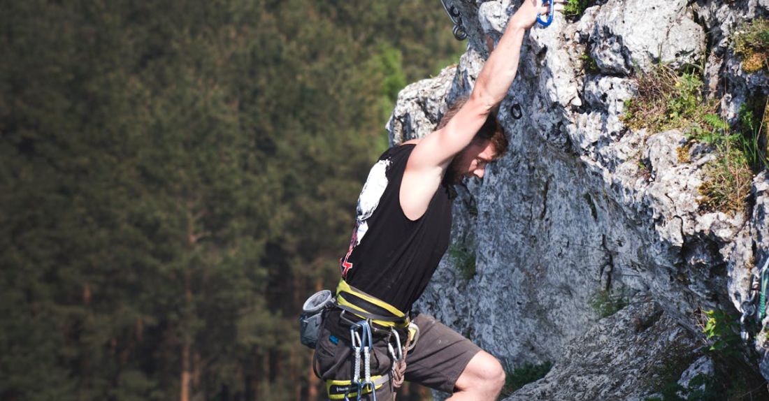 Challenges - Man Wearing Black Tank Top and Brown Shorts Climbing Rock