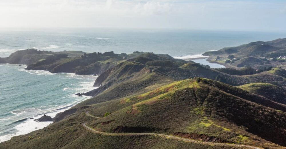 Costs - A scenic view of the ocean and hills