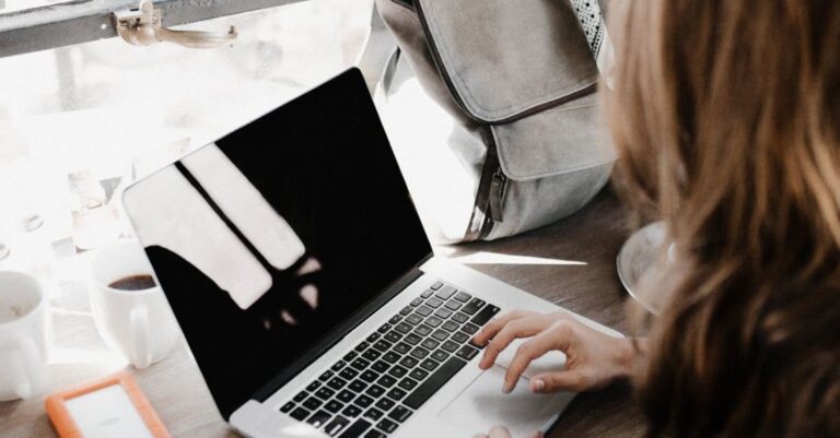 Employers - Close-up Photography of Woman Sitting Beside Table While Using Macbook