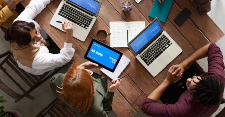 Employees - Top View Photo of Group of People Using Macbook While Discussing