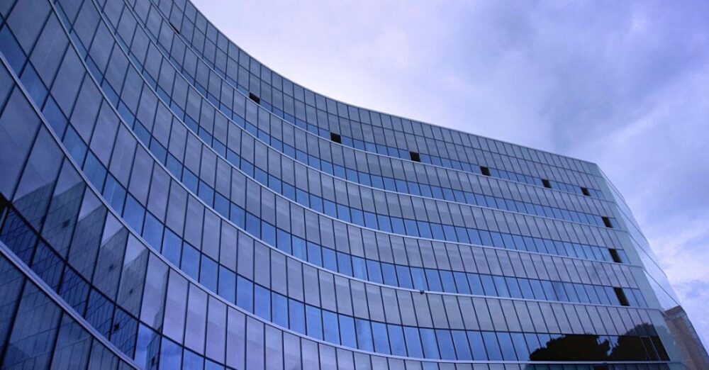 Companies - Fish Eye View Photo of Glass High Story Building over White Cloudy Sky during Daytime