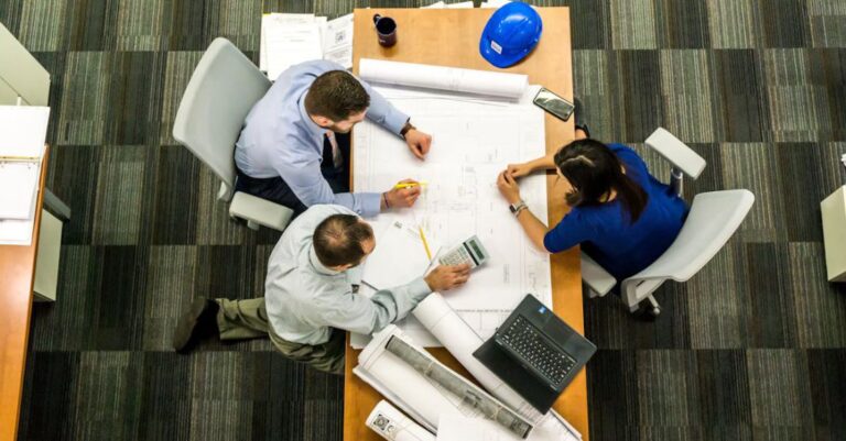 Managers - Three People Sitting Beside Table